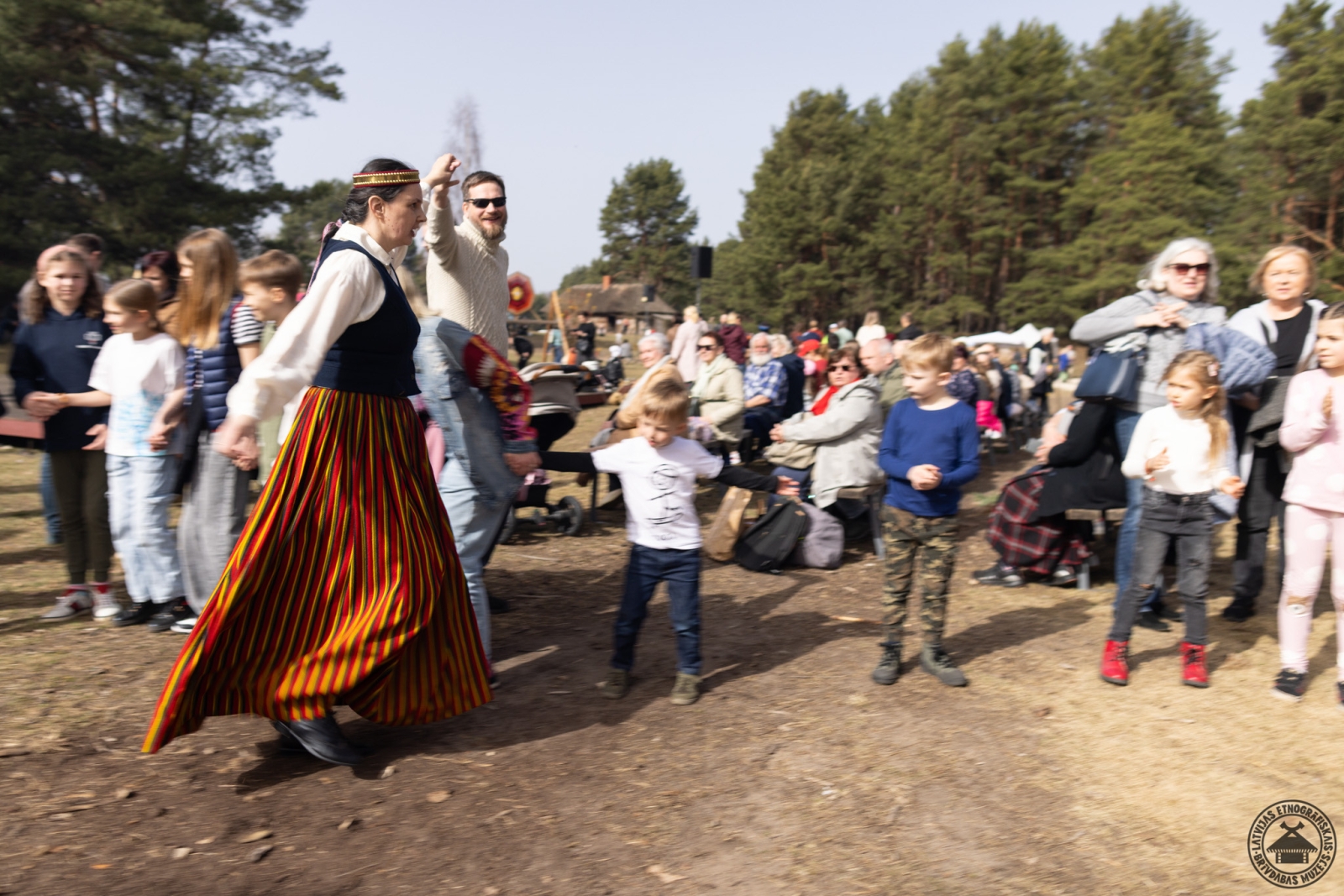 Muzeja apmeklētāji un darbinieki kopīgi iet jautrās Lieldienu rotaļās.